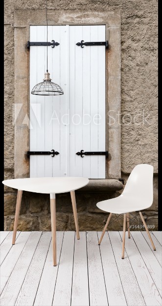 Picture of White narrow wooden closed window shutters with metal ornaments